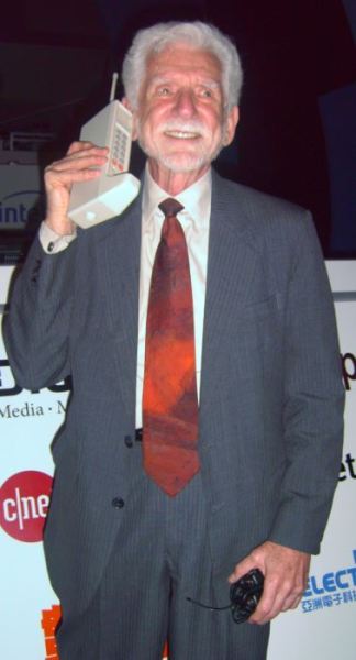 Martin Cooper of Motorola made the first publicized handheld mobile phone call on a prototype DynaTAC model on April 3, 1973. This is a reenactment in 2007.